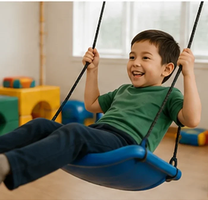 Child using a sensory swing in a supportive therapy environment for a guide about autism assessment and therapy